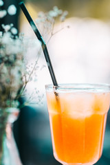 Orange fresh squeezed juice on the wooden table in the restaurant. Close up