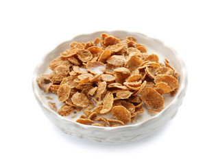 Bowl with healthy cornflakes and milk on white background