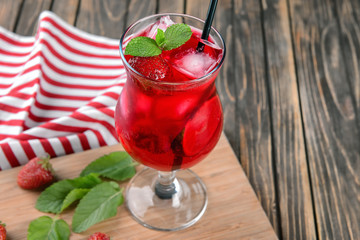 Fresh summer cocktail in glass on wooden board