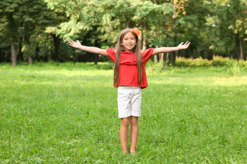 Cute little girl in park on summer day