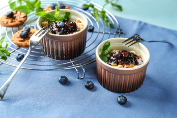 Delicious blueberry desserts with jam on table