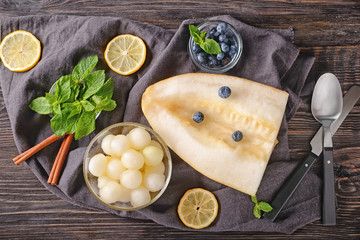 Composition with delicious melon and berries on wooden table