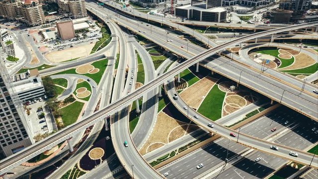 Aerial view of a big highway intersection in Dubai, UAE, at sunset. Transportation and communications concept. 4K timelapse,
