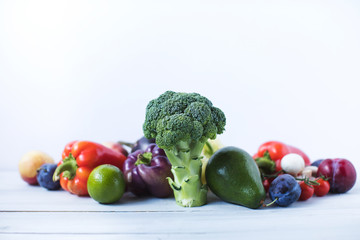 Composition with assorted raw organic vegetables on a wooden background.