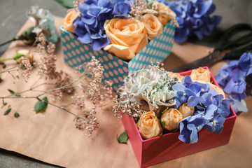 Fototapeta premium Gift boxes with beautiful flowers on table