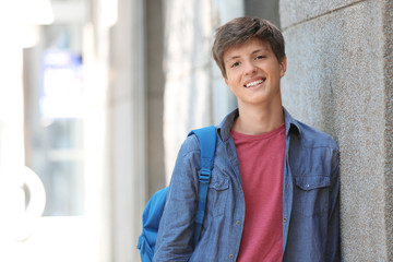 Teenage boy with backpack outdoors