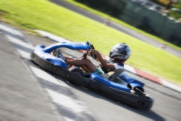 Driver Racing with Go Kart on outdoor circuit