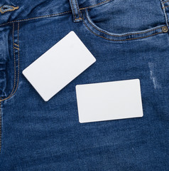 blank white paper business cards on a blue jeans background