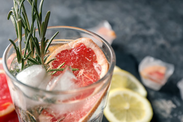 Fresh grapefruit cocktail with rosemary in glass, closeup