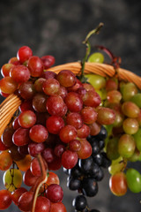 Naklejka na ściany i meble Wicker basket with fresh ripe grapes, closeup