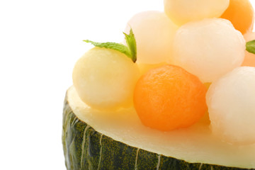 Half of melon with delicious balls on white background, closeup