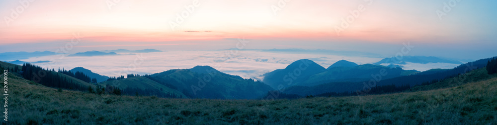 Wall mural waves of clouds over the mountains in the morning