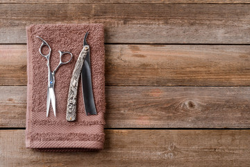 Barber scissors on wooden background