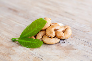 Roasted cashew nuts with fresh leaves.