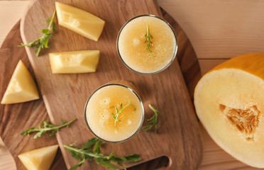 Glasses with delicious melon smoothie on board