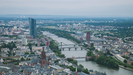 Fototapeta premium aerial view of bridges over Main river and buildings in Frankfurt, Germany