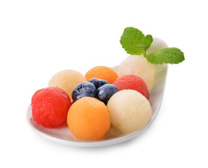 Plate with tasty melon balls and berries on white background