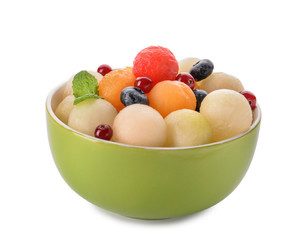 Bowl with tasty melon balls and berries on white background