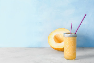 Jar of fresh melon smoothie on light table