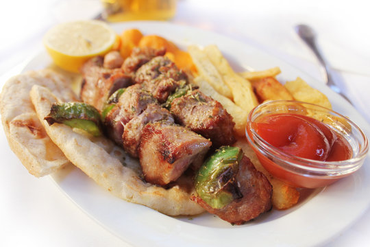 Greek food souviaki. Grilled meat skewer on pita bread