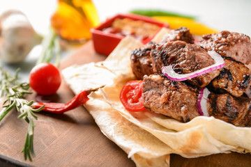Delicious shish kebab on flatbread, closeup