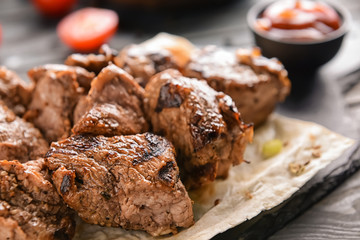 Delicious shish kebab on flatbread, closeup