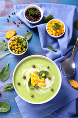 Bowl with delicious zucchini soup on color table