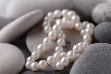 pearl lay on gray stones