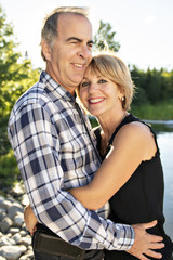 Fototapeta premium Couple outdoors by lake having good time