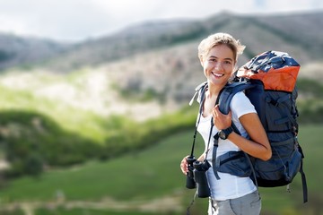 Woman with backpack trekking through the wilderness