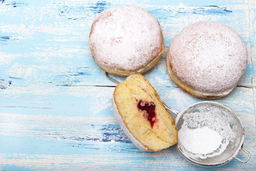 Traditional Polish donuts on wooden background. Tasty doughnuts with jam.
