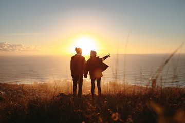 Silhouette of couple standing on mountain - Powered by Adobe