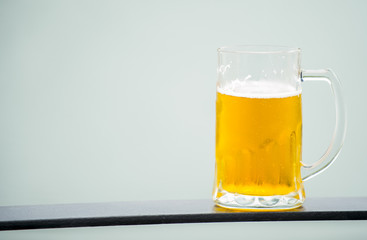 Frosty glass of light beer set isolated on a white background