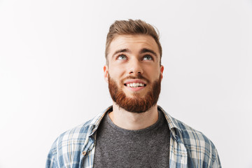 Fototapeta premium Portrait of a smiling young bearded man looking up