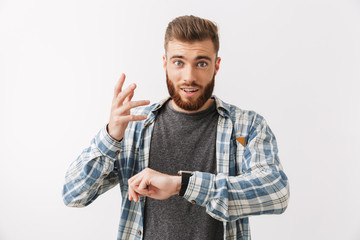 Portrait of an excited young bearded man standing