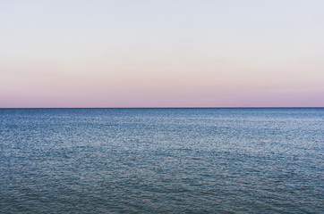Fototapeta premium Evening seascape with endless horizon and calm water