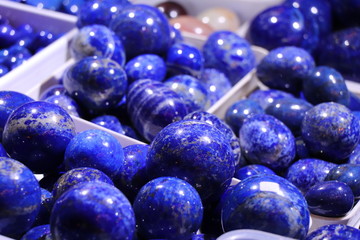 Cobalt blue lapis lazuli balls with white veins. Selected focus. Minerals exhibition.