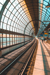 Fototapeta na wymiar modern and curved train station with blurred traveler