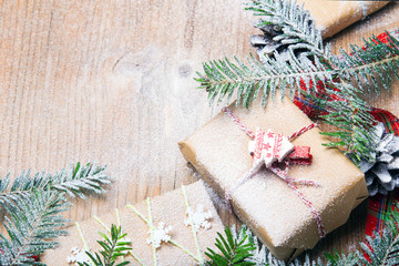 Christmas presents and snow on wooden background, retro style with copy space