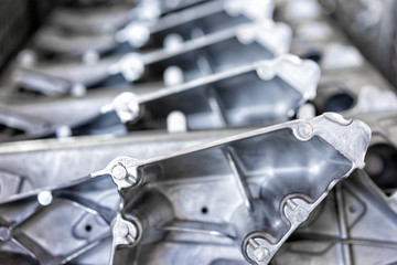 Pile of aluminum automotive parts arm rear, casting process in the automotive factory