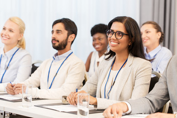 Fototapeta premium business and education concept - group of people at international conference or lecture
