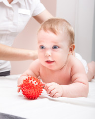 Baby in doctors office receiving osteopathic treatment