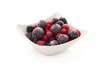 Frozen blackcurrant and redcurrant, close-up, isolated on white background.