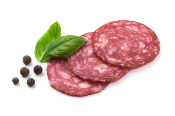Sliced salami smoked sausage, basil leaves and peppercorns, isolated on white background.