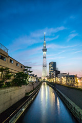TOKYO, JAPAN - June 22, 2018: Tokyo Skytree, Sumida Ward Urban night scene. Tokyo Skytree tower reflections on the canal. Tokyo Sky Tree is one of the famous landmark in Tokyo.
