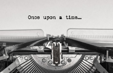 once upon a time... the text is typed on a vintage typewriter with black ink on old paper, close-up
