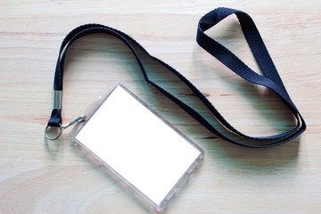 Blank badge mockup isolated on wooden. Lanyard and badge. Plastic badge. Template for presentation...
