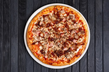 Top view of pizza with ham, beef and caramelized onion