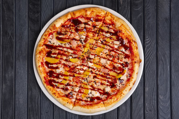 Top view of pizza with chicken, plum and barbecue sauce