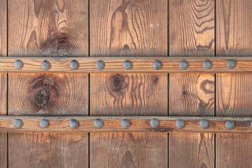 Fragment of an old wooden door of a dark brown color